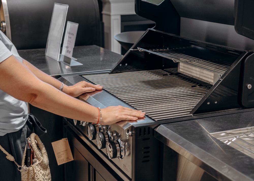 Woman examining a contemporary Built In BBQ in a showroom